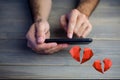 Conceptual image of man hands texting on mobile phone with digital generated red hearts Royalty Free Stock Photo