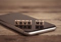 Conceptual image of mobile love me text messaging for Valentines day and online dating technology