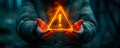 Conceptual image of a person holding a floating exclamation mark in a warning triangle, symbolizing caution, alertness, and Royalty Free Stock Photo