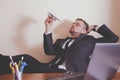 Conceptual image: professional burnout, laziness, unwillingness to work. Portrait of slacker businessman sitting in office with Royalty Free Stock Photo