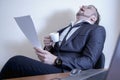 Conceptual image: professional burnout, laziness, unwillingness to work.  Tired and overworked businessman sleeping at his working Royalty Free Stock Photo