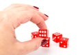 Transparent and red glass dices in hand on white background