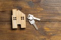 house and key on a wooden surface top view apartment rental Royalty Free Stock Photo