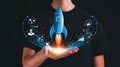 Conceptual image of a startup launch with a rocket ship held by a hand and business icons Royalty Free Stock Photo