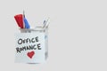 Conceptual image of sticky notepaper with heart shape depicting office romance Royalty Free Stock Photo