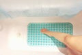 Conceptual image of taking safety precaution using an anti-slip in bathtub to prevent accidents