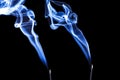 Blue incense smoke forming shapes. Royalty Free Stock Photo