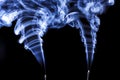 Two plumes in blue incense smoke. Royalty Free Stock Photo