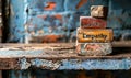 Conceptual image of vintage wooden blocks stacked with the word Empathy on a rustic table against a worn blue wall, depicting