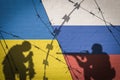 Conceptual image of war between Russia and Ukraine with shadow of soldier against wall with flags