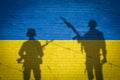 Conceptual image of war between Russia and Ukraine with shadow of soldier against wall with flags
