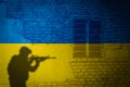 Conceptual image of war between Russia and Ukraine with shadow of soldier against wall with flags