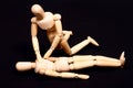 Conceptual image of wooden manikins administering CPR