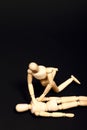 Conceptual image of wooden manikins administering CPR