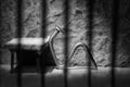 Conceptual jail photo with iron nail sitting behind bars artistic conversion