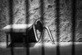 Conceptual jail photo with iron nail sitting behind bars artistic conversion Royalty Free Stock Photo