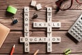 Conceptual keywords on wooden table with elements of game making crossword