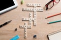 Conceptual keywords on wooden table with elements of game making crossword
