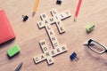 Conceptual keywords on wooden table with elements of game making crossword