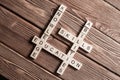 Conceptual keywords on wooden table with elements of game making crossword