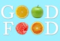 A conceptual message made up of the letters and fruits of lemon, orange, green apple and raspberry shows `good food`.