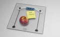 Conceptual and modern still life delicious apple and yellow posit note text saying stop sugar stuck on bathroom scale in weight