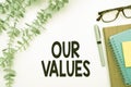 Conceptual OUR VALUES text on a white surface surrounded with some office supplies Royalty Free Stock Photo