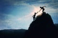 Conceptual painting with two friends climbing a mountain together, helping each other to reach the top peak. Climbers silhouettes