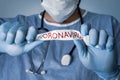 Conceptual photo for Coronavirus outbreaking. Covid-19 concept. The doctor crumples the white paper that says Coronavirus