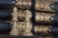 Conceptual photo. Chess pieces on a book in a library with books on the bookshelf background. Chess piece photography. Remote off