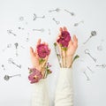 Conceptual photo. Hands with flowers and keys