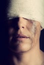 Conceptual photo of a hurt woman crying with bandage around her head