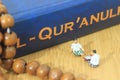 Conceptual Photo, Islam Man or Muslim, Learn Read Al Quran, Al Qur`an Near The Real One and Wooden Prayer Bead, with his