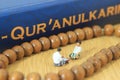 Conceptual Photo, Islam Man or Muslim, Learn Read Al Quran, Al Qur`an Near The Real One and Wooden Prayer Bead, with his