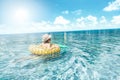Conceptual photo of little boy in summer hat swimming in big blue water. A lot of copy space. Traveler. Tourism. Wanderlust