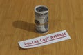 Conceptual Photo, money paper tight by Rubber Band and text Dollar Cost Average, or DCA golden rule investment