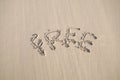 A word \'FREE\' written on the sand on the beach. Royalty Free Stock Photo
