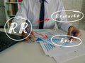 Conceptual photo about RR Resource Rent with written abbreviation. Business Man Checking Documents on background