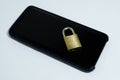 Conceptual photo security on mobile phones. A closed padlock on a cell phone on a white background Royalty Free Stock Photo