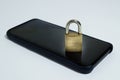 Conceptual photo security on mobile phones. A closed padlock on a cell phone on a white background Royalty Free Stock Photo