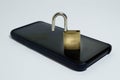 Conceptual photo security on mobile phones. A open padlock on a cell phone on a white background Royalty Free Stock Photo