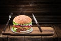 Conceptual photo of typical desired tasty hot homemade burger or cheeseburger on wood table