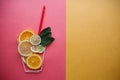 Conceptual photography. Citrus lemonade or juice from fresh fruits in a glass of tubules