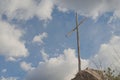 Wooden cross planted on top of a rock Royalty Free Stock Photo