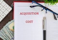 A conceptual phrase on the topic of ACQUISITION COST business. Business concept Royalty Free Stock Photo