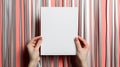 Conceptual pop-art mockup, blank paper with copy-space in hands on colorful stripy background