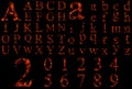 Conceptual red burning fire fonts isolated on black Royalty Free Stock Photo