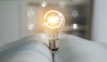 Conceptual representation of knowledge and ideas with a light bulb glowing above an open book surrounded by innovative Royalty Free Stock Photo