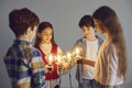 Conceptual shot of happy smart kids standing in circle holding shining light bulbs Royalty Free Stock Photo