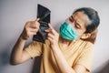 Asian woman open her empty wallet but no money because of she was unemployed in situation of covid-19 pandemic outbreak. Royalty Free Stock Photo